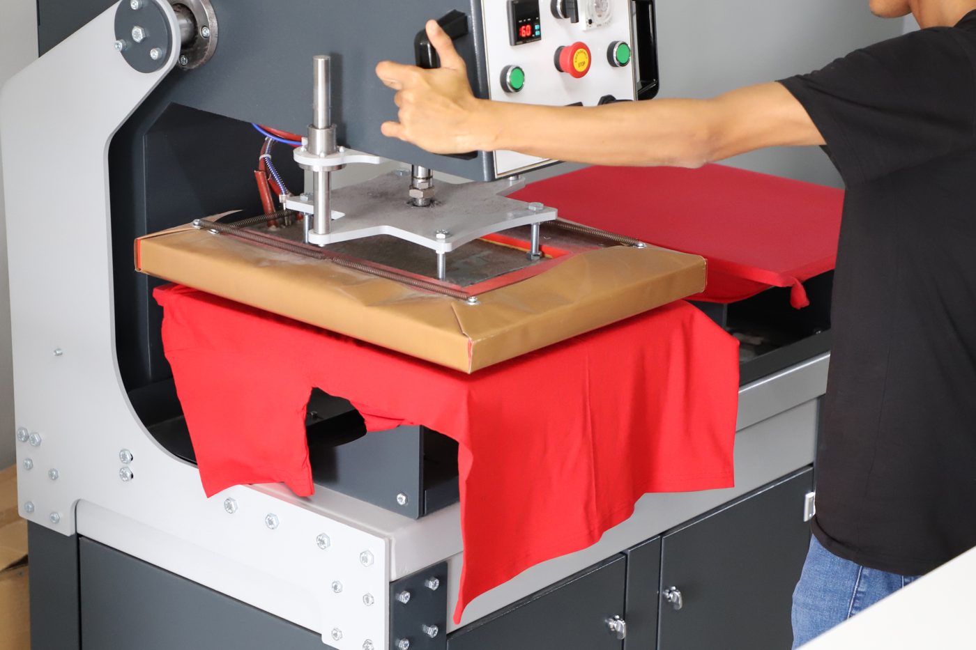 Heat press applying a transfer to a garment